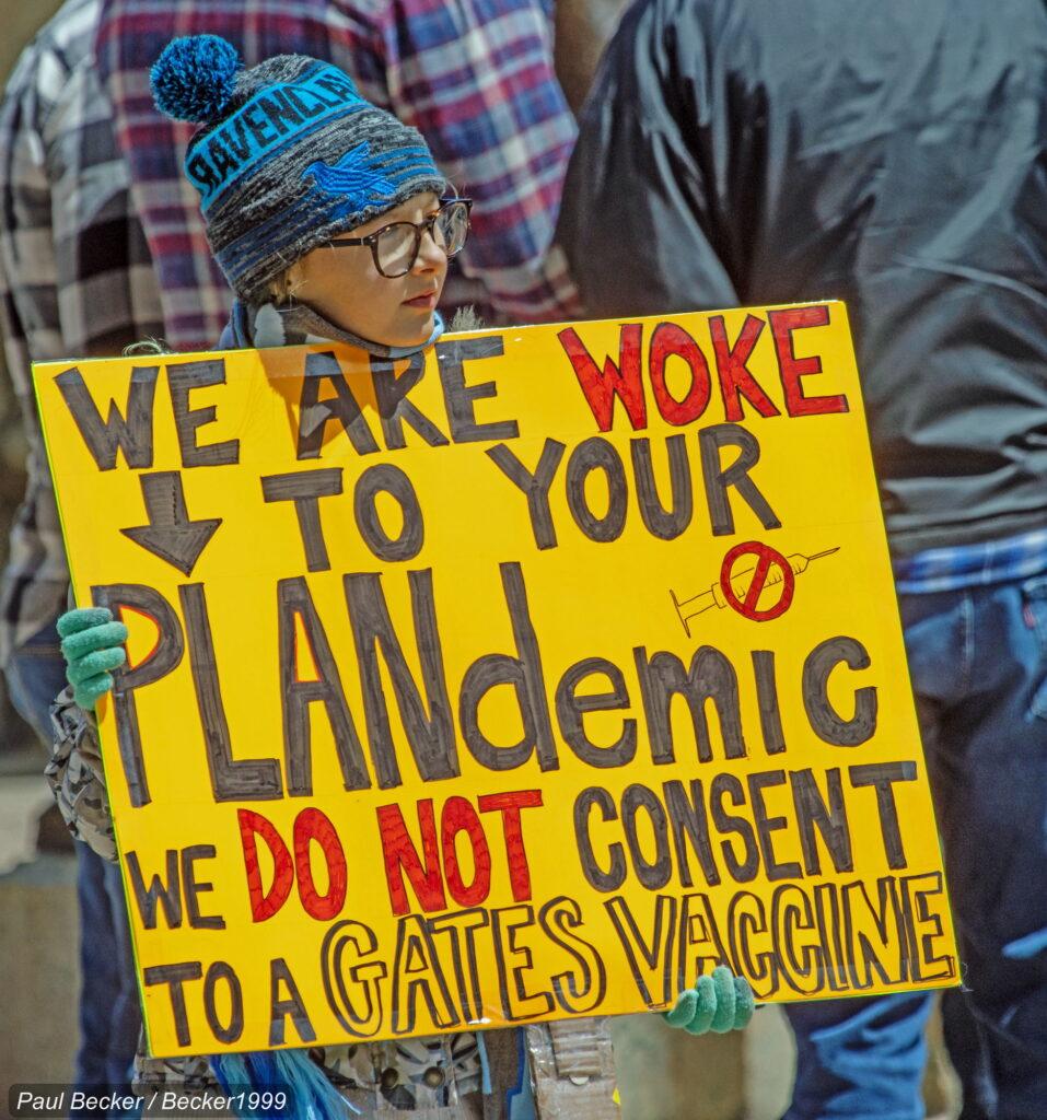conspiracy theory poster held by a child