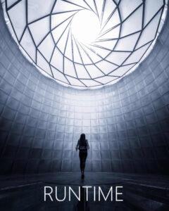 Runtime cover (woman standing under a brightly-lit dome)